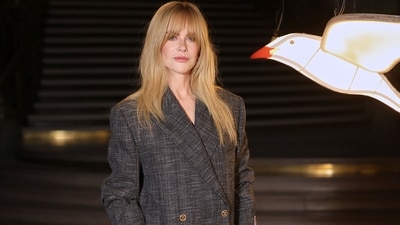 Nicole Kidman poses upon arrival at the Chanel Women's Wear Spring Summer 2027 collection presented in Paris, France. She wore a tweed Chanel blazer dress, reminiscent of the iconic Chanel tweed look.&nbsp; (AP Photo/Thomas Padilla)