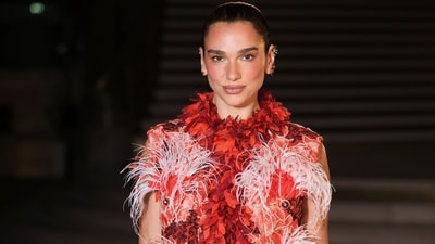 Several stars were present at the showcase, including singer-songwriter Dua Lipa. She was clicked posing upon arrival, dressed in a red dress adorned with feathered elements. She styled it with a bejewelled Chanel bag.&nbsp; (AP Photo/Thomas Padilla)