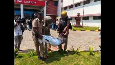 Police detain an SFI activist at the protest site in Central University of Kerala’s campus in Kasaragod on Tuesday. (HT PHOTO)