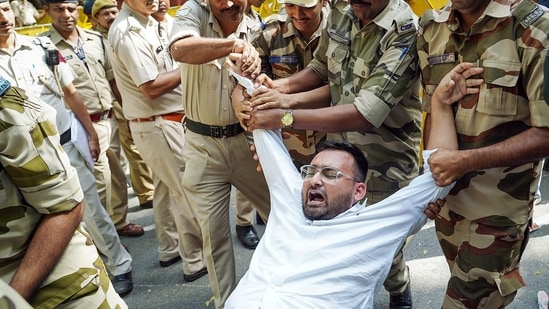 Delhi Police detains a protestor demanding resignation of Chief Election Commissioner Gyanesh Kumar, in New Delhi.