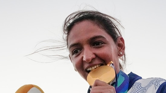 India's captain Harmanpreet Kaur poses for photographs with Gold medal after winning the women's final T20I cricket match between India and Sri Lanka