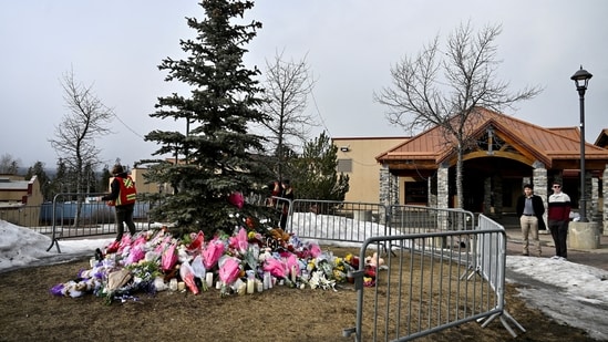 Workers install a fence around a makeshift memorial for the victims two days after a deadly mass shooting took place at a school in the town of Tumbler Ridge, British Columbia, Canada. REUTERS/Jennifer Gauthier/File Photo
