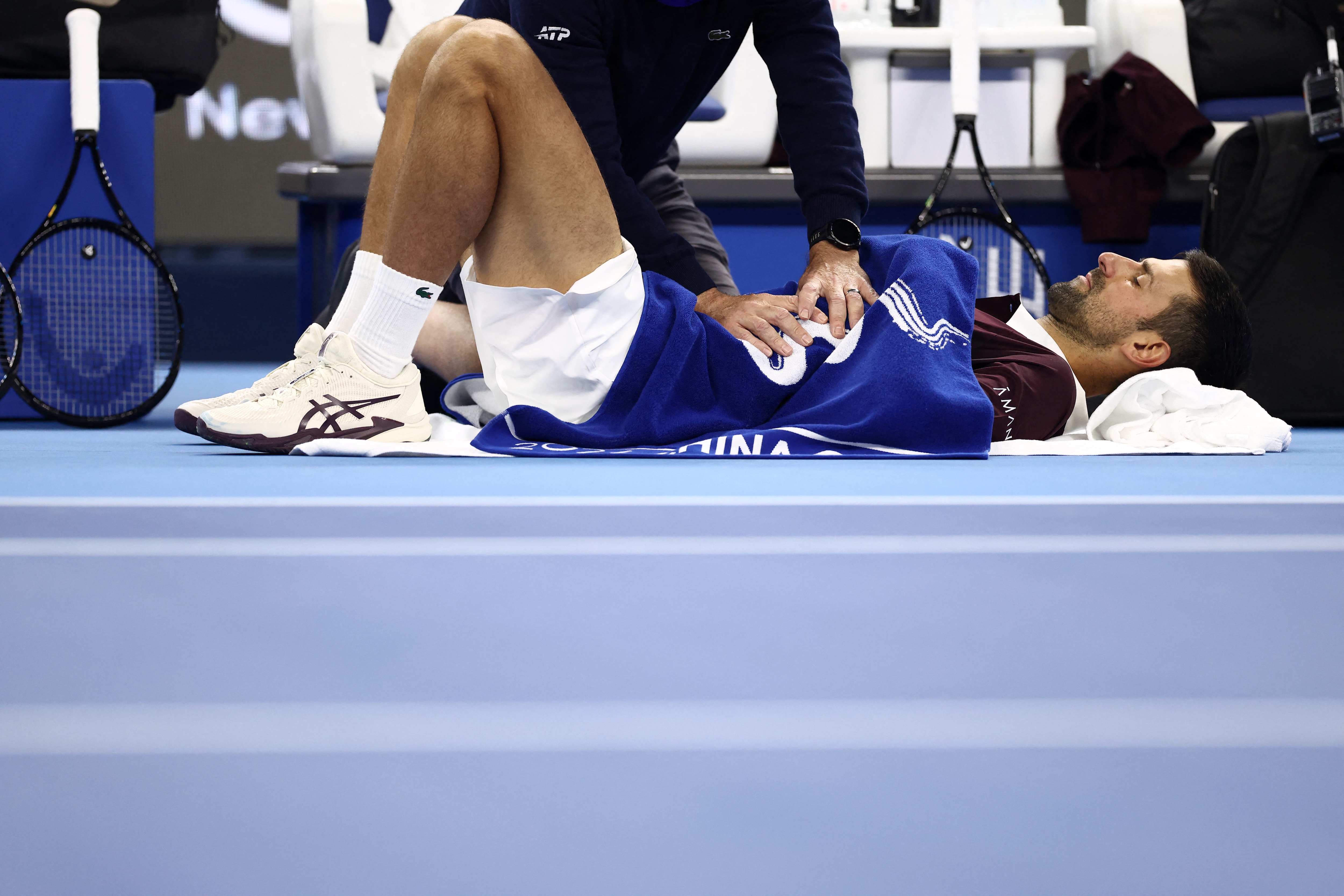 Serbia's Novak Djokovic receives medical attention during his round of 16 match against China's Bu Yunchaokete (REUTERS)