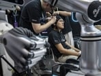 A BrainCo technician has electrodes attached to his head for a demonstration at the exhibition of the World Robot Conference in Beijing, China, on Wednesday, Aug. 19, 2026.