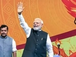 Prime Minister Narendra Modi waves to supporters upon his arrival to address the Viksit Bharat Sankalp Sabha, in New Delhi.(PTI)