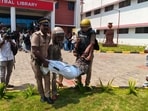 Police detain an SFI activist at the protest site in Central University of Kerala’s campus in Kasaragod on Tuesday. (HT PHOTO)