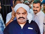 Prayagraj Police with jailed-mafia Atiq Ahmed outside Sabarmati Central Jail as he is being shifted to Prayagraj. (PTI)