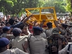 Protestors breach security barricades during a protest against Chief Election Commissioner Gyanesh Kumar near Jantar Mantar, in New Delhi on Saturday.
