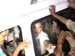 Lok Sabha LoP Rahul Gandhi he hands out water bottles to Delhi policemen from bus during detention. (X/@PTI_News)