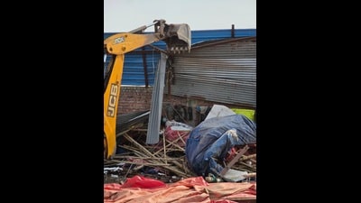 A JCB machine demolishing an illegal structure in Manimajra on Wednesday. (HT Photo)