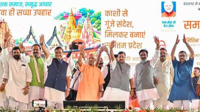 BJP national president Nitin Nabin, Uttar Pradesh CM Yogi Adityanath, deputy CM Keshav Prasad Maurya, Assam CM Himanta Biswa Sarma, and others wave to the crowd at the concluding ceremony of the Seva Sankalp Yatra, in Varanasi on Wednesday. (ANI PHOTO)