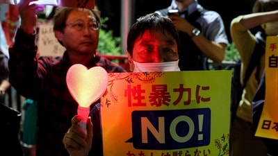 A demonstrator holds a placard during a protest outside the Prime Minister's office following the killing of a Japanese woman in Okinawa, for which a US Marine is a suspect, in Tokyo, Japan. (REUTERS)