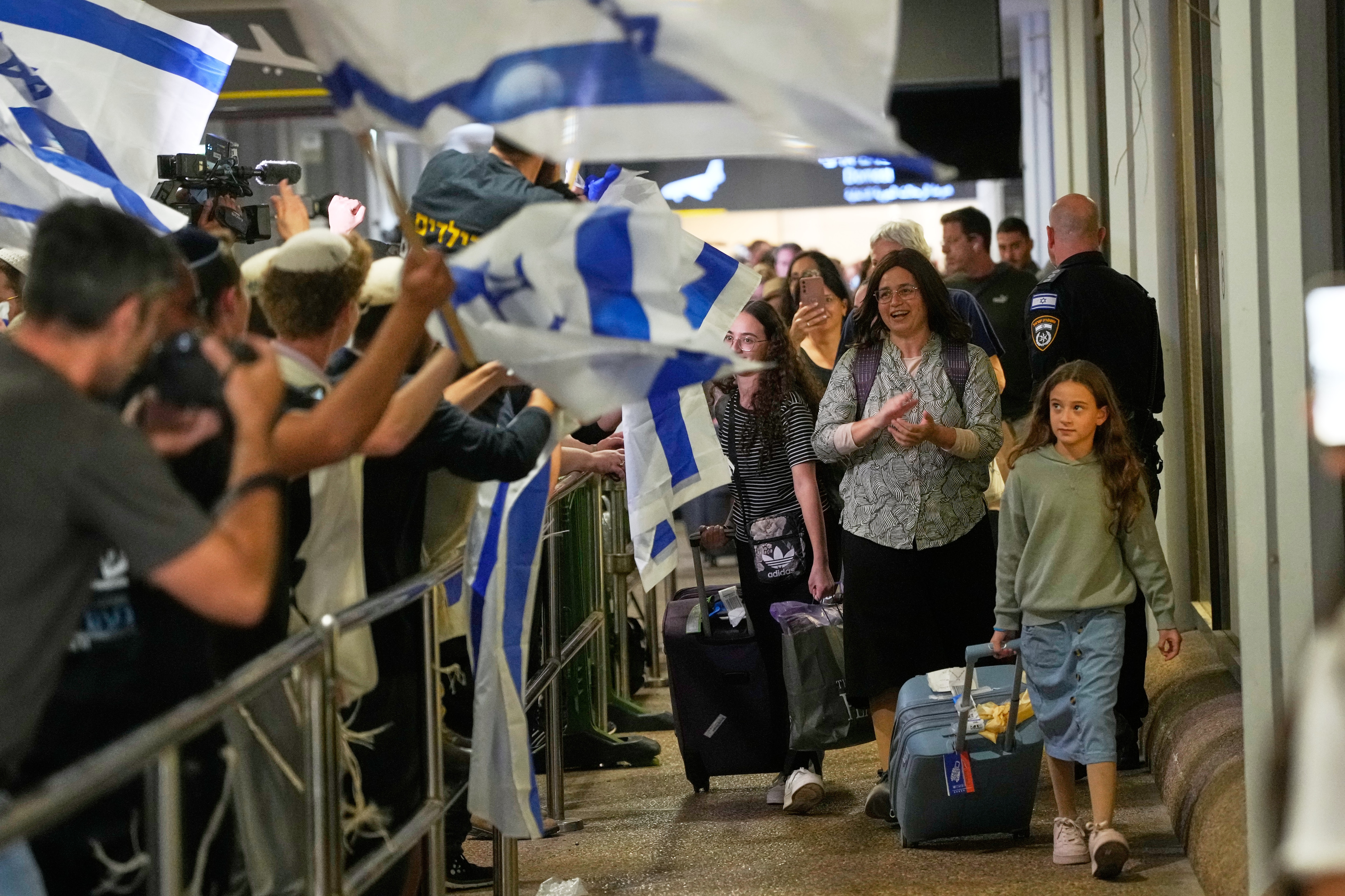 Israeli passengers who had been aboard a FlyDubai aircraft that made an emergency landing in Saudi Arabia are welcomed at the arrivals gate at Ben Gurion International Airport near Tel Aviv, Israel, Wednesday, (AP Photo) Israeli passengers who had been aboard a FlyDubai aircraft that made an emergency landing in Saudi Arabia are welcomed at the arrivals gate at Ben Gurion International Airport near Tel Aviv, Israel, Wednesday, (AP Photo)