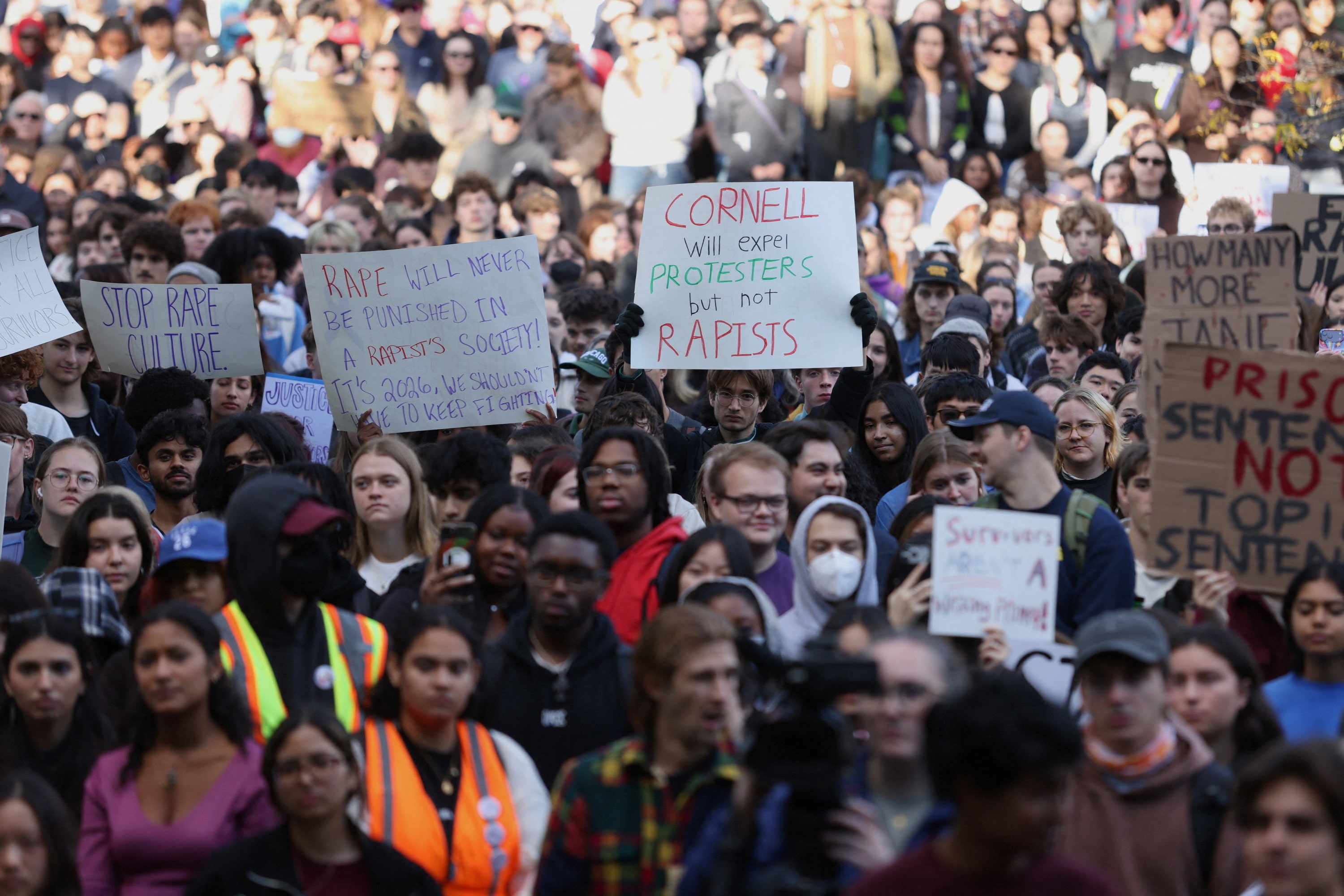 Demonstrators hold placards during a Justice for Survivors rally at Cornell University in Ithaca, New York,. (REUTERS)