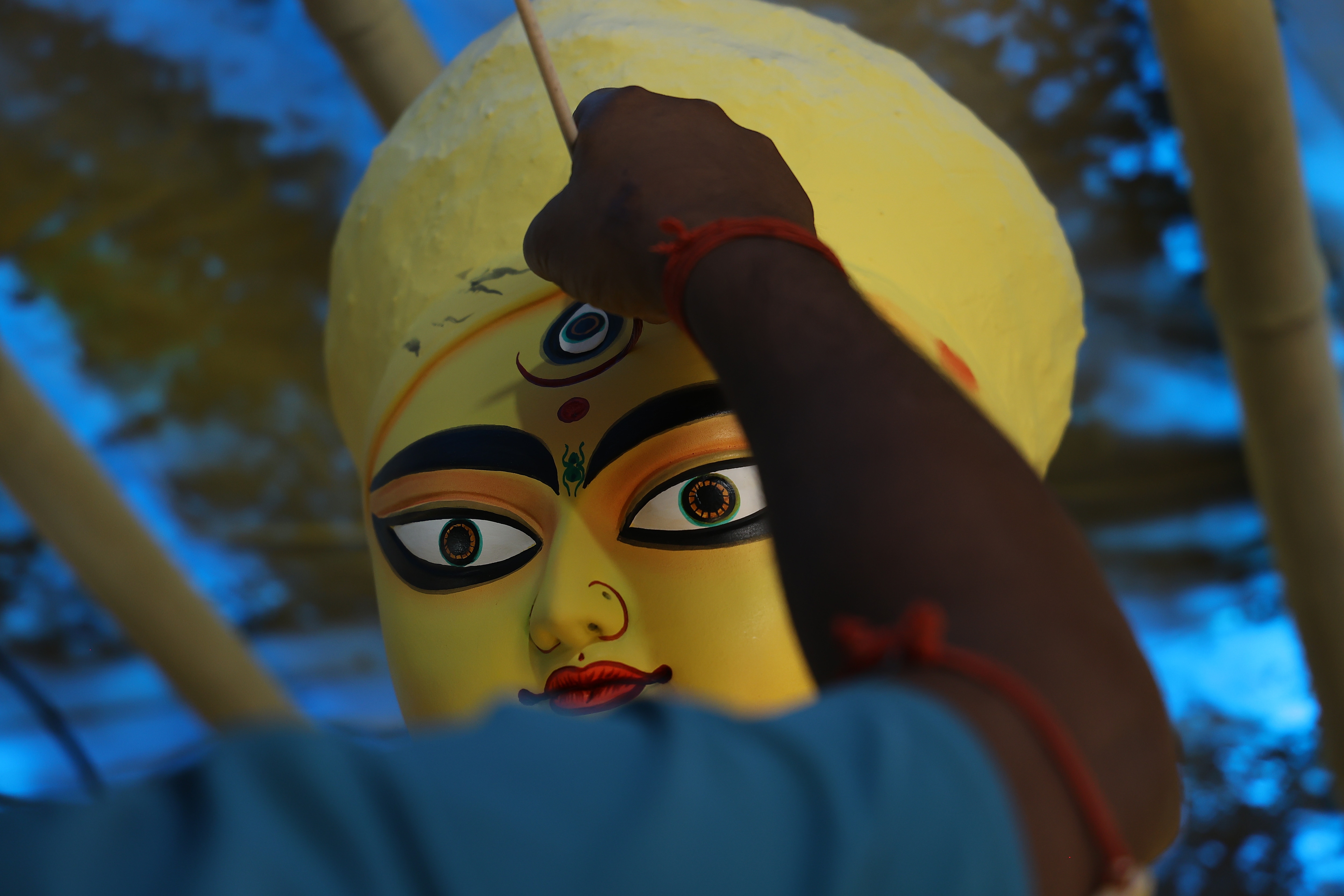 An artisan painting Goddess Durga's idol, defining the facial features. (Photo: Manoj Verma)