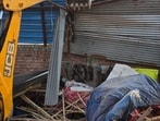 A JCB machine demolishing an illegal structure in Manimajra on Wednesday. (HT Photo)