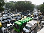 Traffic moves through Connaught Place as security was tightened ahead of the INDIA bloc protest in New Delhi.