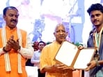 Chief minister Yogi Adityanath distributing appointment letters in Lucknow on Thursday. (HT PHOTO)