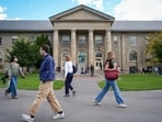 Students walk the campus grounds at Cornell University in Ithaca, New York on October 8.