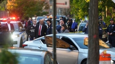 Members of law enforcement gather at the scene after a shooting reportedly involving US Immigration and Customs Enforcement (ICE) officers in the Bronx borough of New York City, on Thursday,