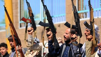 Fighters loyal to the Houthi authorities, take part in a rally to recruit more fighters, in Sanaa on October 7, 2026. The Houthis claimed a flurry of attacks on Saudi targets on October 7 including firing a ballistic missile at Riyadh airport, as the group battles for territory in Yemen against government forces supported by the kingdom. (Photo by Mohammed HUWAIS / AFP)