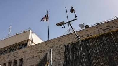 The British diplomatic flag flutters outside the British consulate in Jerusalem, after the Israeli government ordered the UK to shut down its operations. (AFP)