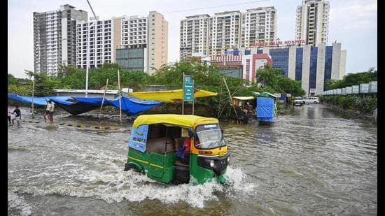 Commuters make way through a waterlogged road as the swollen Gomti inundates Shaheed Path area, in Lucknow on Thursday. (ANI Photo)