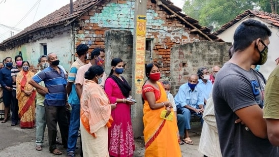 Voters stand in long queues on polling day in West Bengal.