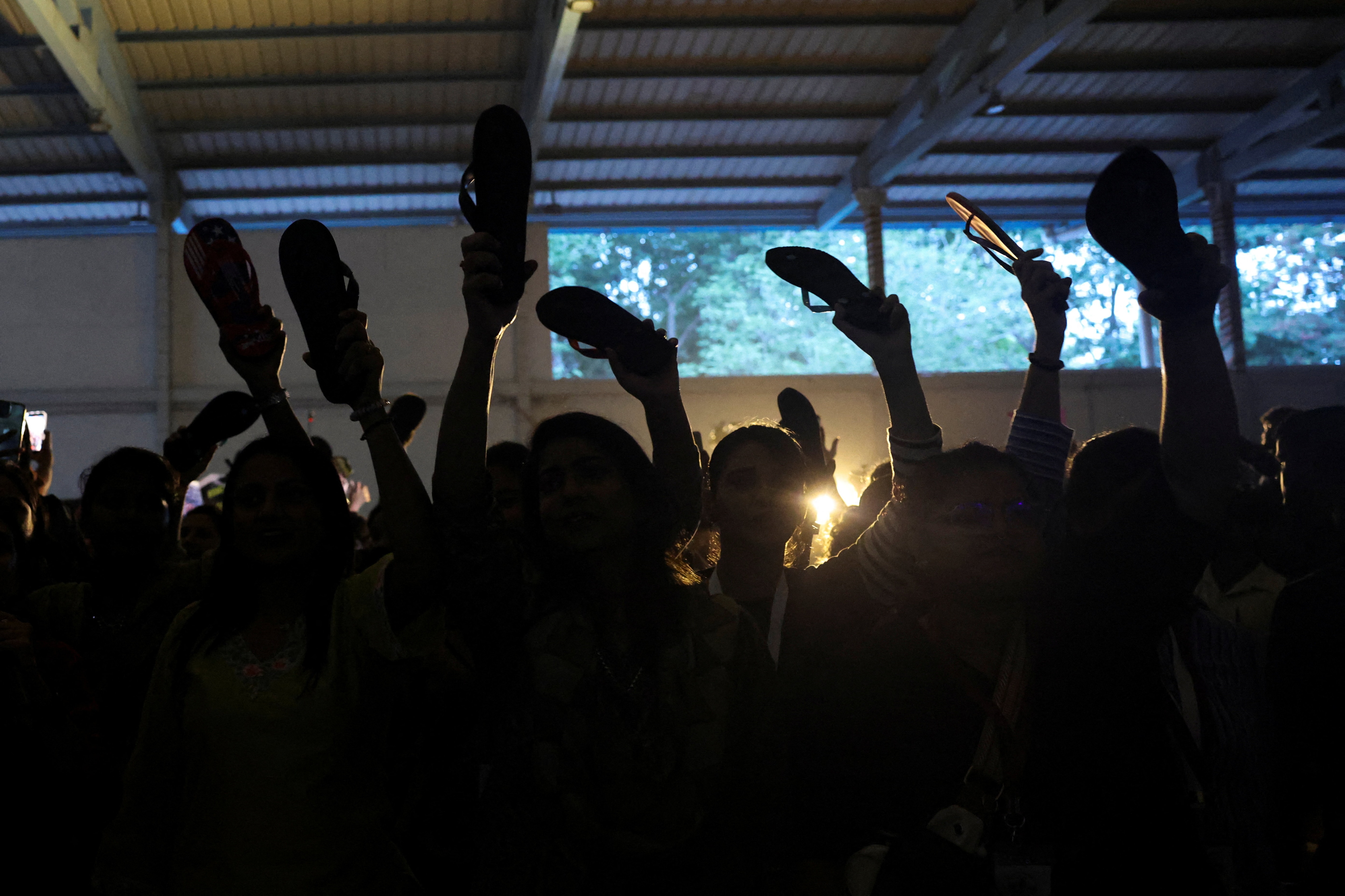 Women supporters of the Cockroach Janta Party (CJP) hold up flip-flops while protesting for women's safety in Bengaluru, India, October 8, 2026. REUTERS/Priyanshu Singh (REUTERS)