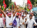 Samajwadi Party workers hold placards and raise slogans during a protest march against Chief Election Commissioner Gyanesh Kumar near the District Magistrate’s office in Kaiserbagh.