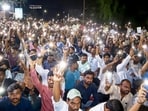 MPSC aspirants display phone flashlights during a protest over various issues, in Pune, Saturday, Oct. 3. (PTI)