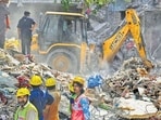NDRF personnel and other teams conduct a rescue operation at the collapse site in Seemapuri.