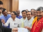 Secretary state assembly Hem Pant handing over certificafe of election to BJP leader Dinesh Arya.