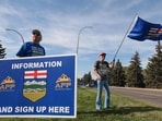Separatists waves the Alberta flag by the roadside during an event advocating for Alberta's separation from Canada in Medicine Hat, southwestern Alberta, on September 23. (AFP)