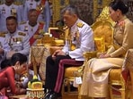 Former royal bodyguard Sineenat Wongvajirapakdi prostrates in front of King Rama X, while Queen Suthida watches in this image from 2019 (HT image)