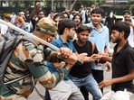 A security official carries out lathi charge on protestors at Jantar Mantar during the July agitation.
