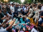 Lok Sabha LoP Rahul Gandhi stops Delhi Police from detaining Congress MP Priyanka Gandhi Vadra and others during the INDIA bloc MPs' protest against Chief Election Commissioner Gyanesh Kumar near Jantar Mantar, in New Delhi on Wednesday. (AICC)