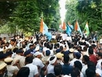 Congress supporters gather around the bus as Congress president Mallikarjun Kharge, Lok Sabha LoP Rahul Gandhi, along with INDIA bloc MPs, move towards Rajghat after a meeting at Moets restaurant, in New Delhi on Thursday. 
