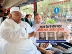 Congress president Mallikarjun Kharge and party leader Rahul Gandhi aboard a bus carrying INDIA bloc leaders to Mahatma Gandhi's memorial at Rajghat to stage a peaceful protest demanding the resignation of Chief Election Commissioner Gyanesh Kumar, in New Delhi.