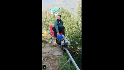 A farmer uses a monotrain to carry apple-laden crates in Dhangvi village, located in Shimla’s Kotkhai, on Friday. (HT Photo)