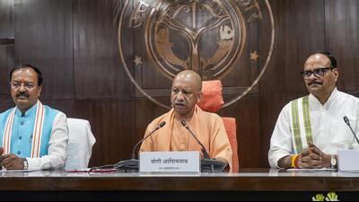 Chief minister Yogi Adityanath addresses a press conference alongside deputy chief ministers Keshav Prasad Maurya and Brajesh Pathak following a state cabinet meeting at Lok Bhawan, in Lucknow on Friday. (PTI Photo)