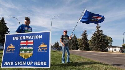 Separatists waves the Alberta flag by the roadside during an event advocating for Alberta's separation from Canada in Medicine Hat, southwestern Alberta, on September 23. (AFP) Separatists waves the Alberta flag by the roadside during an event advocating for Alberta's separation from Canada in Medicine Hat, southwestern Alberta, on September 23. (AFP)