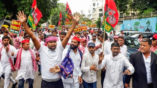 Samajwadi Party workers hold placards and raise slogans during a protest march against Chief Election Commissioner Gyanesh Kumar near the District Magistrate’s office in Kaiserbagh. (ANI)