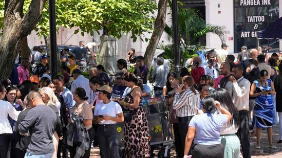 People evacuated from a building gather at a square after a severe earthquake hit the country, in Panama City.(AFP)