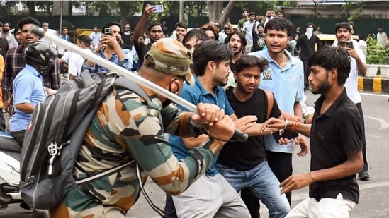 A security official carries out lathi charge on protestors at Jantar Mantar during the July agitation.