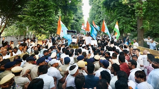 Congress supporters gather around the bus as Congress president Mallikarjun Kharge, Lok Sabha LoP Rahul Gandhi, along with INDIA bloc MPs, move towards Rajghat after a meeting at Moets restaurant, in New Delhi on Thursday.