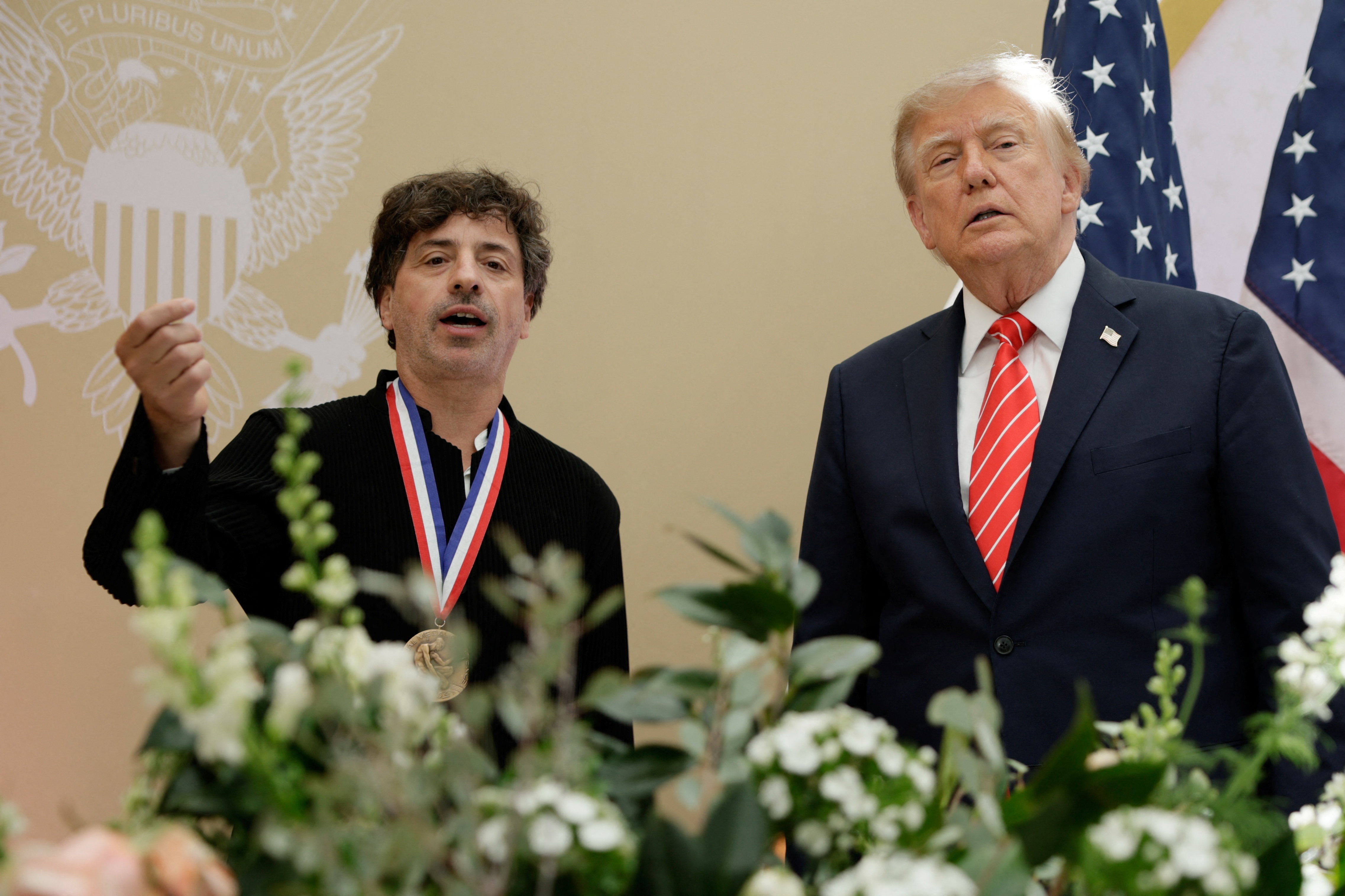 US President Donald Trump stands with Google co-founder Sergey Brin, after presenting him with the National Medal of Science during the "A New Golden Age" summit. (REUTERS)