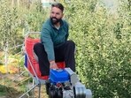 A farmer uses a monotrain to carry apple-laden crates in Dhangvi village, located in Shimla’s Kotkhai, on Friday. (HT Photo)