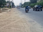 A resident of Sector 46, said the road shoulders remained covered in dust, while ongoing roadside work had added to the inconvenience. (HT)