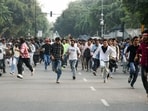 Protesters being dispersed by Delhi Police amid CJP Protest at Connaught Place, in New Delhi on Saturday.